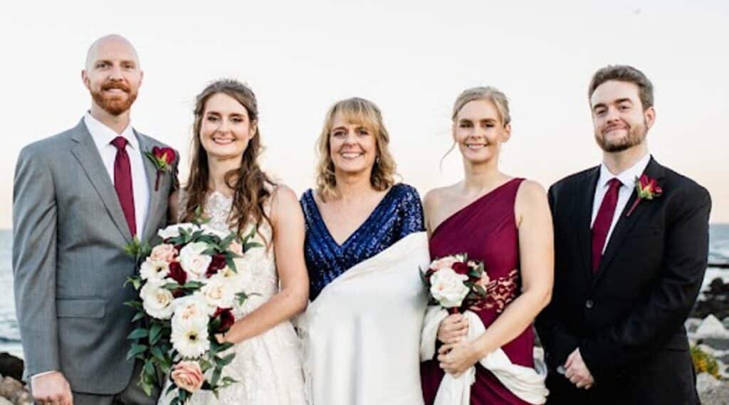 Featuring Judy Donovan Hann as our employee spotlight today! In this photo, she's wearing a blue sparkly dress and white shall at her daughter's wedding.