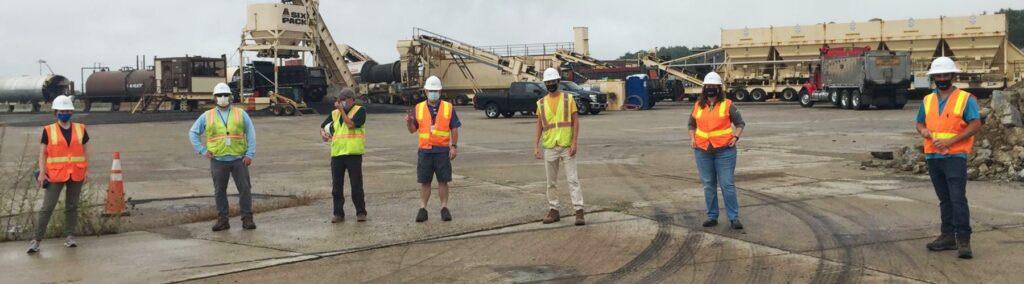 Seven members of our team on an airfield working as construction inspectors.