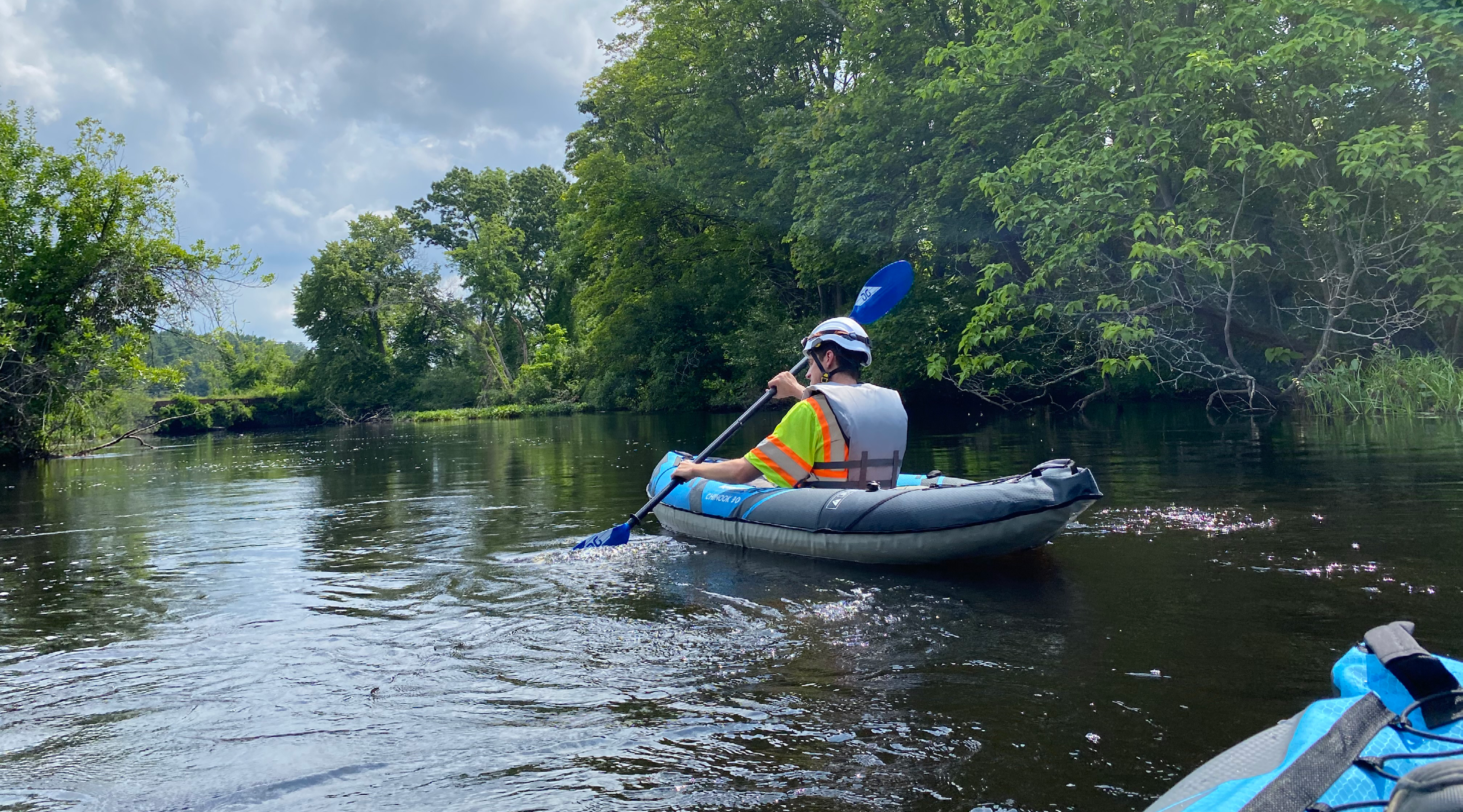 Hoyle Tanner staff kayaking to a culvert inspection on a river in Chelmsford, MA.