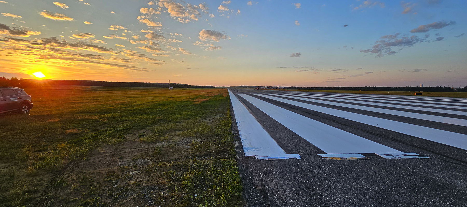 Sunset over Presque Isle International Airport and fresh white paint for threshold bars.