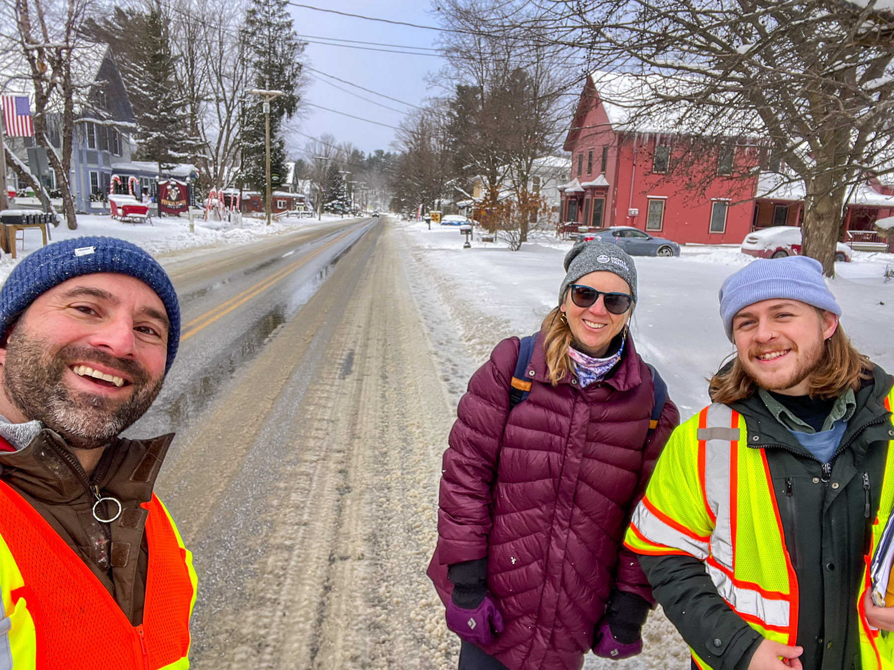 An image of Zach and two colleagues in the winter doing a site visit. The trio is smiling facing the camera while snow is all around them in Vermont.