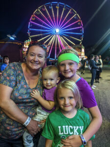 Briana and her children. They are all smiling, looking at the camera.