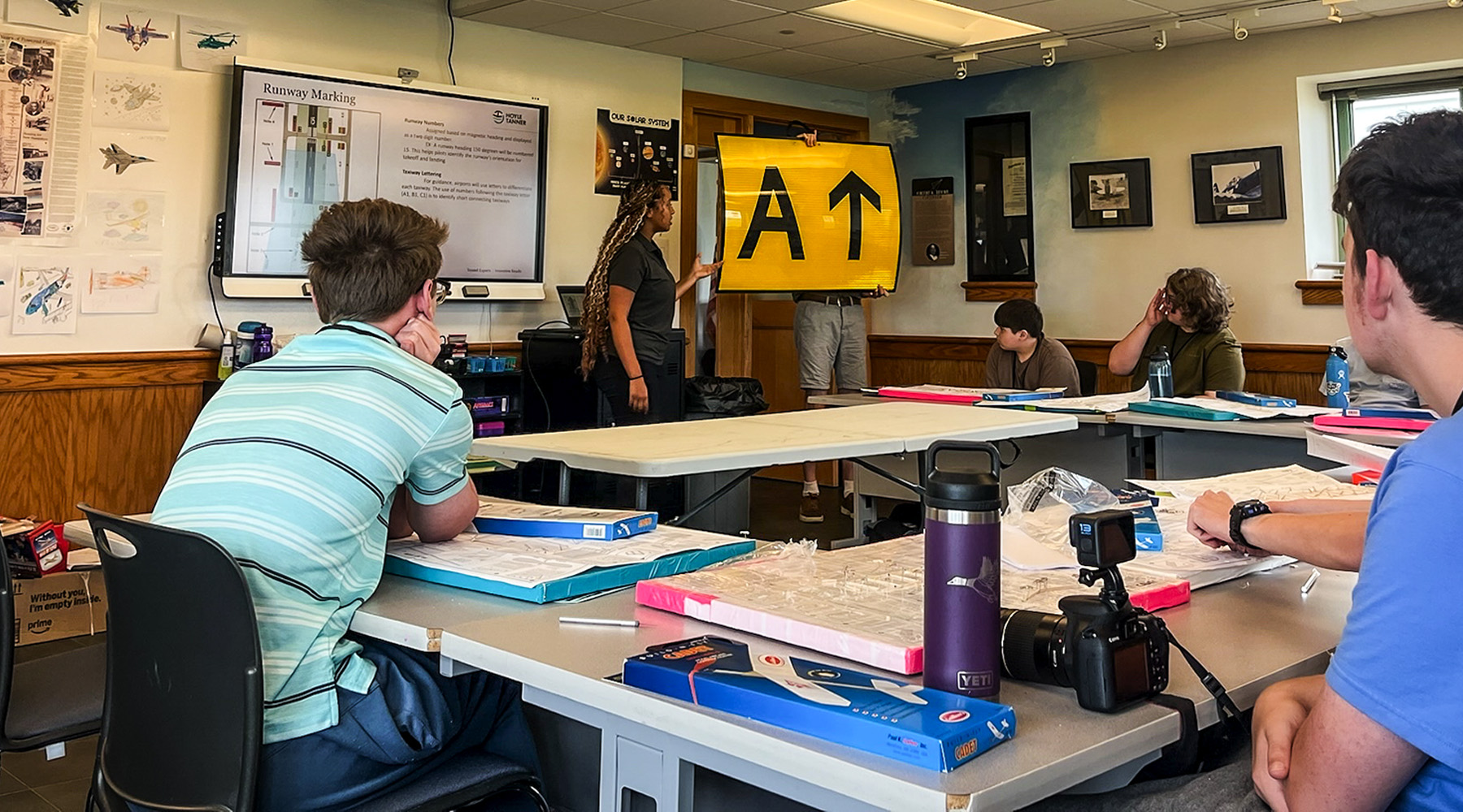 Rebekah presenting at the front of the classroom