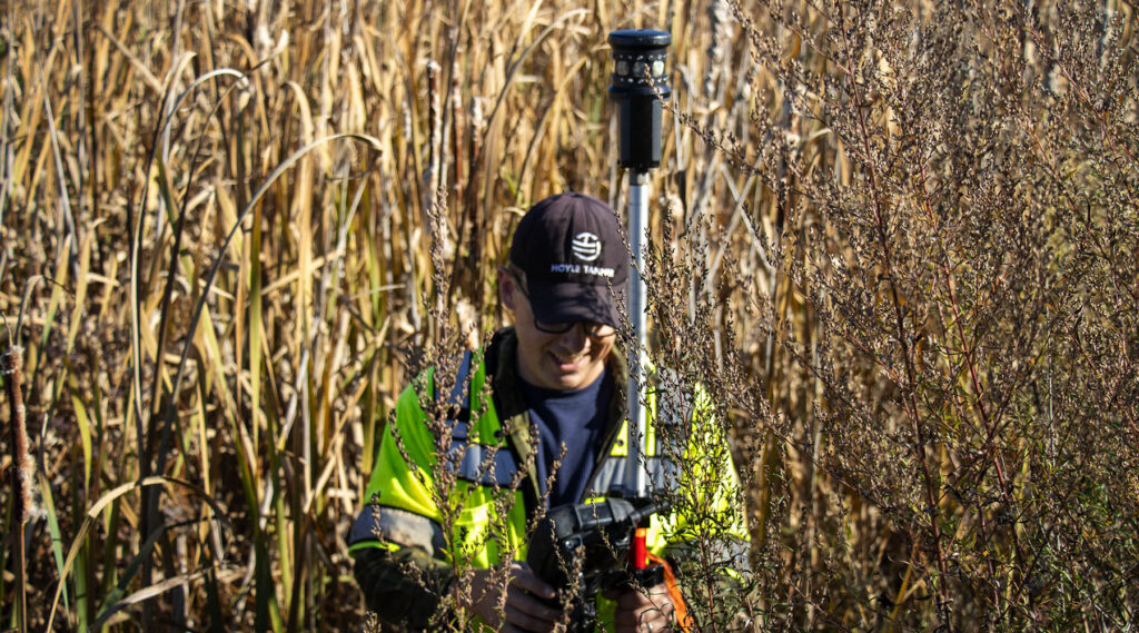 David Jeffery in wetlands taking survey