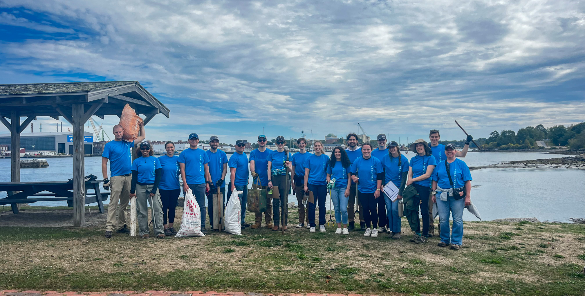Beach clean up volunteering. A group of Hoyle Tanner employees in their matching blue volunteer shirts